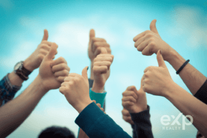 Real estate agents giving the thumbs up to the best real estate brokerage!