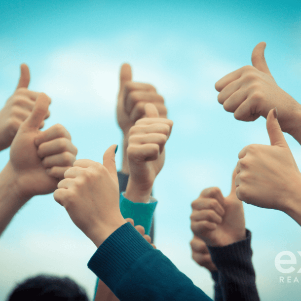 Real estate agents giving the thumbs up to the best real estate brokerage!