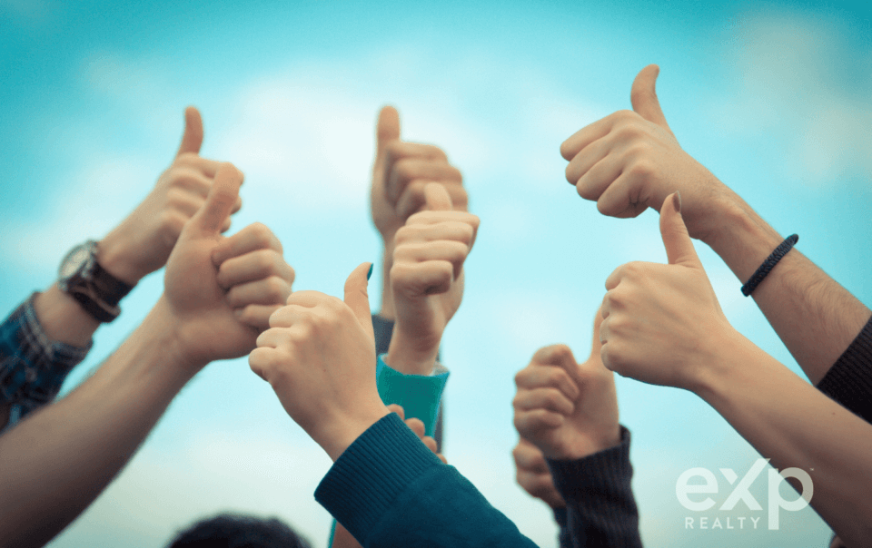 Real estate agents giving the thumbs up to the best real estate brokerage!