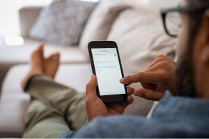 Man viewing email marketing newsletter from his real estate agent
