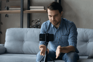 Man On Couch Recording Instagram Video