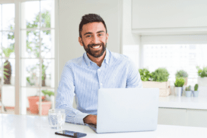 Real estate agent on laptop researching ways to find quality real estate leads
