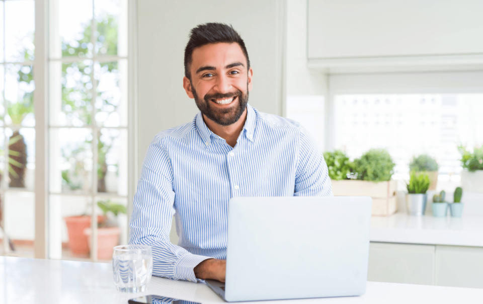 Real estate agent on laptop researching ways to find quality real estate leads