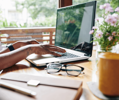 Woman searching online for the best real estate schools for her new license