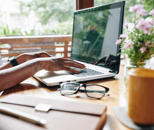 Woman searching online for the best real estate schools for her new license