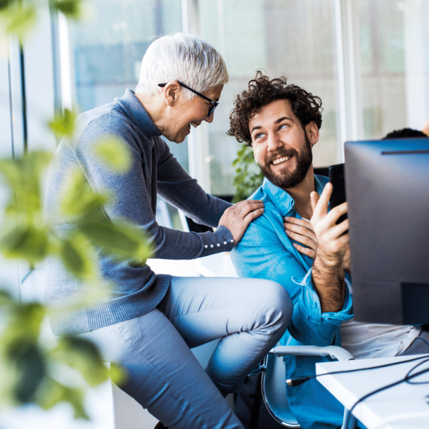 Mentor showing man how to write real estate blogs on Building Better Agents training site.