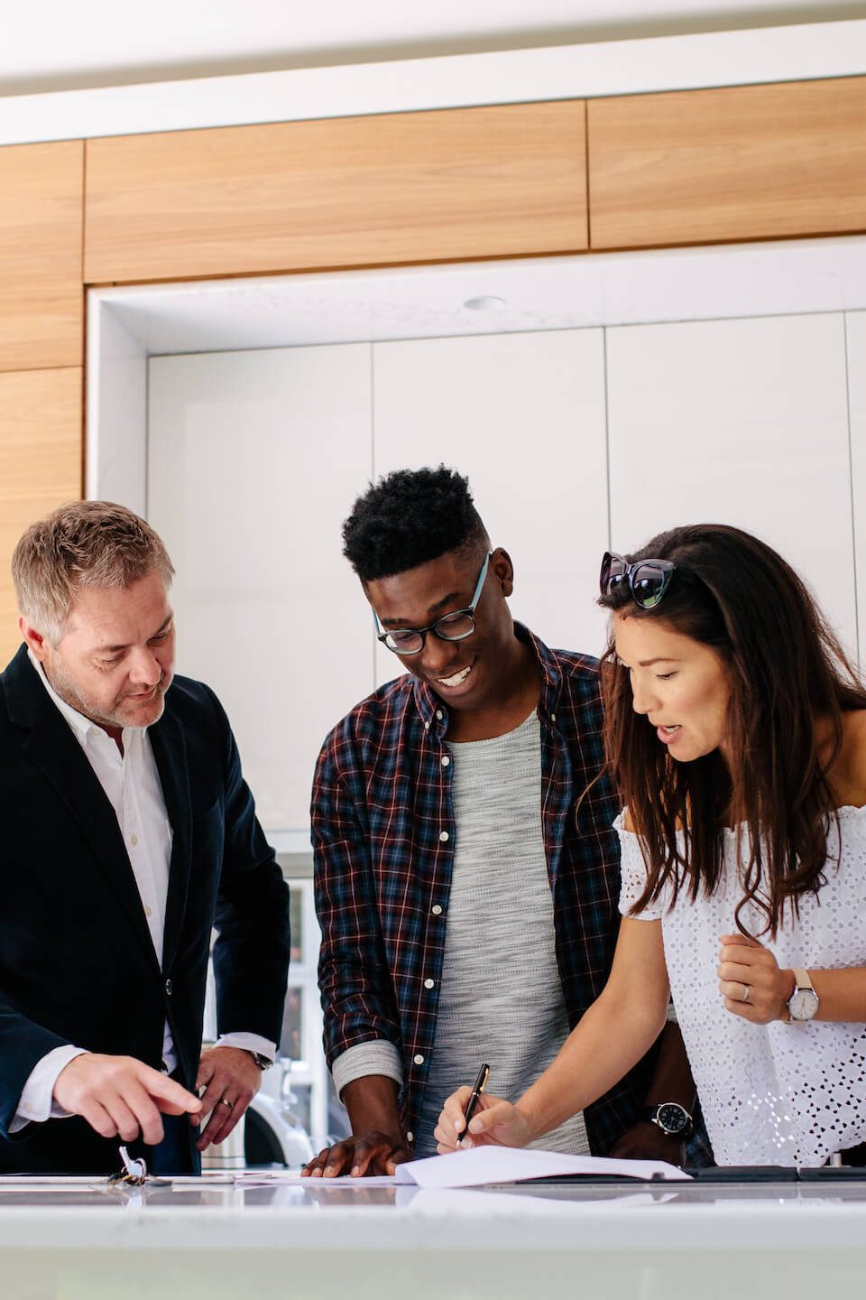 Real estate agent helping home sellers fill out a contract