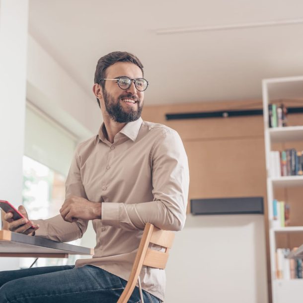 smiling-student-with-a-phone-JKTERSH